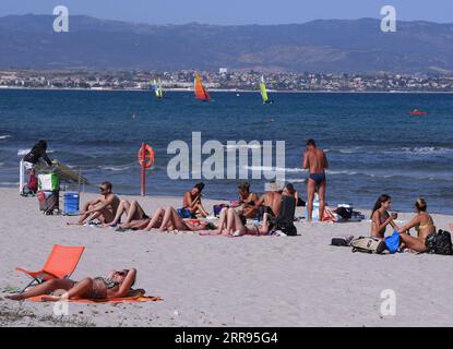 210528 -- CAGLIARI ITALY, May 28, 2021 -- People relax on a beach in Cagliari, Sardinia, Italy, on May 28, 2021. All Italian regions have turned to yellow since Monday, indicating a low risk of contagion, and the lowest level of anti-COVID-19 restrictions, according to the country s national health authorities. Photo by /Xinhua ITALY-SARDINIA-CAGLIARI-COVID-19-RESTRICTIONS-EASE AlbertoxLingria PUBLICATIONxNOTxINxCHN Stock Photo