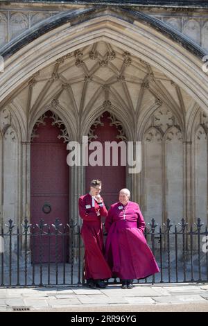 Two clergy outside the front west entrance of Winchester Cathedral, Winchester, Hampshire, England, United Kingdom, Europe Stock Photo