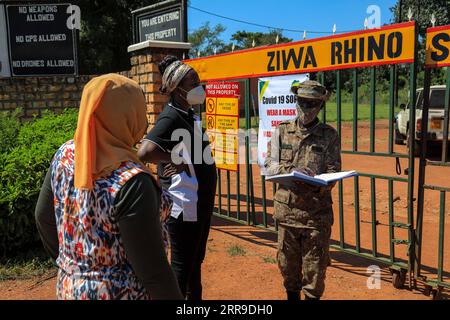 210611 -- NAKASONGOLA, June 11, 2021 -- A Uganda Wildlife Authority UWA ranger R talks to local tourists at the Ziwa Rhino Sanctuary in Nakasongola district, Central region, Uganda, June 10, 2021. Ziwa Rhino Sanctuary was on Thursday reopened to tourist after a management dispute led to its closure weeks ago. UWA, a state-run conservation agency in a statement issued said tourist can now visit the 33 rhinos at the sanctuary. Photo by /Xinhua UGANDA-NAKASONGOLA-RHINO SANCTUARY-REOPENED HajarahxNalwadda PUBLICATIONxNOTxINxCHN Stock Photo