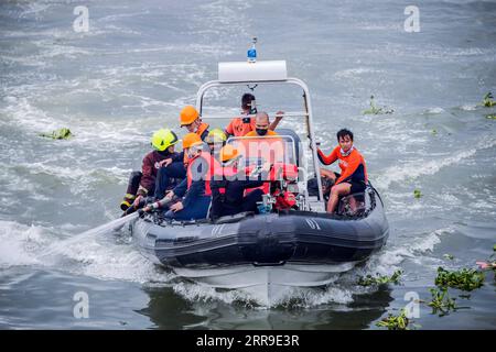 210612 -- MANILA, June 12, 2021 -- Firefighters and members of the Philippine Coast Guard are seen on a rubber boat as they respond to put out a fire engulfing a cargo ship at a wharf in Manila, the Philippines on June 12, 2021. Six crew members were injured and two others unaccounted for when a small cargo ship caught fire while refueling here at a wharf on Saturday morning, the Philippine Coast Guard PCG said.  SPOT NEWSPHILIPPINES-MANILA-CARGO SHIP-FIRE RouellexUmali PUBLICATIONxNOTxINxCHN Stock Photo