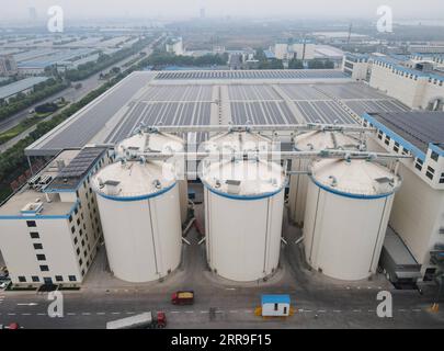 210613 -- XINGTAI, June 13, 2021 -- Aerial photo shows the grain silos and worshops of a local noodle factory in Xingtai, north China s Hebei Province, June 9, 2021. With the summer wheat harvest underway, farmers in north China s Xingtai have been busy in the fields to reap the year s premium grains. In Xingtai, a total of 65 farmers have joined the Jinshahe specialized cooperative that provides them with technical guidance in crop harvesting. The cooperative will sell freshly harvested crops to a local noodle factory where staple products are made and sold to customers.  CHINA-HEBEI-XINGTAI- Stock Photo