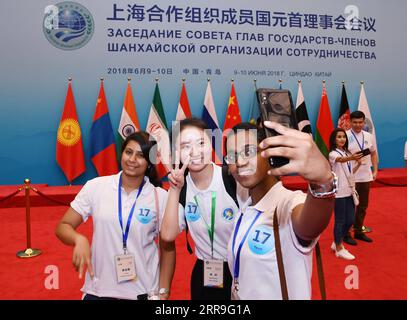 210615 -- BEIJING, June 15, 2021 -- File photo taken on July 16, 2018 shows attendees of the third Shanghai Cooperation Organization SCO Youth Campus taking selfies in Qingdao, east China s Shandong Province.  Xinhua Headlines: 20 years on, China calls for closer SCO community with shared future LixZiheng PUBLICATIONxNOTxINxCHN Stock Photo