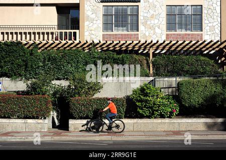 210615 -- SAN MATEO, June 15, 2021 -- A man rides on the street in San Mateo, California, the United States, June 14, 2021. California Governor Gavin Newsom and government health officials announced the official reopening of the state from Tuesday following months of anticipation. The reopening means that vaccinated people in California can go maskless in public, there will be no more limitations on out-of-state travelers, and California retail businesses can go back to full capacity.  U.S.-CALIFORNIA-SAN MATEO-REOPENING WuxXiaoling PUBLICATIONxNOTxINxCHN Stock Photo