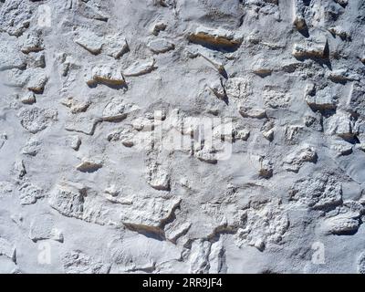 Rustic cement wall painted white Stock Photo