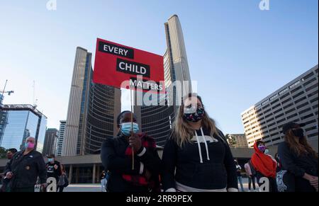 210627 -- OTTAWA, June 27, 2021 -- A woman shows a placard with words EVERY CHILD MATTERS as she takes part in a memorial event for the 215 children whose remains have been found buried at a former Kamloops residential school, in Toronto, Canada, May 30, 2021. Photo by /Xinhua Xinhua Headlines: Hundreds of unmarked graves unveil tip of Canada s genocidal history ZouxZheng PUBLICATIONxNOTxINxCHN Stock Photo