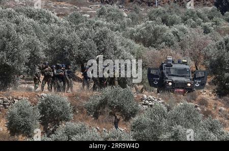 210702 -- NABLUS, July 2, 2021 -- Israeli soldiers and members of Israeli border police are seen deployed during a protest against the expanding of Jewish settlements in the village of Beita, south of the West Bank city of Nablus, July 2, 2021. Photo by Nidal Eshtayeh/Xinhua MIDEAST-NABLUS-PROTEST ChenxLin PUBLICATIONxNOTxINxCHN Stock Photo