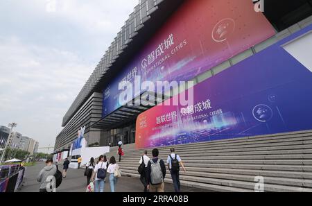 210708 -- SHANGHAI, July 8, 2021 -- Participants enter the venue of the 2021 World Artificial Intelligence Conference WAIC in east China s Shanghai, July 8, 2021. The 2021 WAIC kicked off in China s Shanghai on Thursday. With the theme of Intelligent Connectivity, Inspirational Cities , this year s conference is aimed to promote global exchange and cooperation, and enhance the common welfare of mankind. More than 10 AI chips, as well as innovative products brought by more than 300 major AI companies, will be shown at the conference, which will last to Saturday.  EyesonSciCHINA-SHANGHAI-AI-CONF Stock Photo