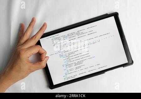 Programming and coding concept. Code generation: Fingers click to insert a new line in the code Stock Photo