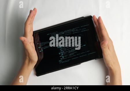 Programming and coding concept. Program code creation: hands inserting a new piece of code into the program being edited Stock Photo