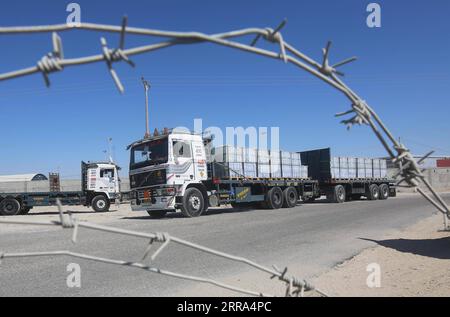 210715 -- RAFAH, July 15, 2021 -- A loaded trailer truck arrives at the Kerem Shalom commercial crossing in the southern Gaza Strip city of Rafah, July 14, 2021. Israel on Monday decided to ease the tight restrictions imposed two months ago on export, import and fishing in the Gaza Strip, Palestinian officials said. The import of medical supplies and raw materials for industry and textiles will be allowed from Israel to Gaza through the commercial crossing of Kerem Shalom. Photo by /Xinhua MIDEAST-GAZA-RAFAH-KEREM SHALOM COMMERCIAL CROSSING KhaledxOmar PUBLICATIONxNOTxINxCHN Stock Photo