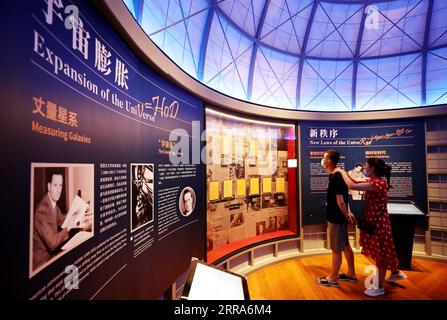 210718 -- SHANGHAI, July 18, 2021 -- People view an exhibition introducing astronomy theories at the Shanghai Astronomy Museum in east China s Shanghai, July 18, 2021. The Shanghai Astronomy Museum, the world s largest planetarium in terms of building scale, opened to the public on Sunday. Covering an area of approximately 58,600 square meters, the museum is located in the China Shanghai Pilot Free Trade Zone Lingang Special Area. It is a branch of the Shanghai Science and Technology Museum.  CHINA-SHANGHAI-ASTRONOMY MUSEUM CN FangxZhe PUBLICATIONxNOTxINxCHN Stock Photo