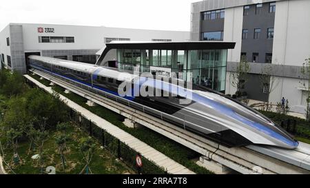210720 -- QINGDAO, July 20, 2021 -- Aerial photo taken on July 20, 2021 shows China s new maglev transportation system in Qingdao, east China s Shandong Province. China s new high-speed maglev train rolled off the production line on Tuesday. It has a designed top speed of 600 km per hour -- currently the fastest ground vehicle available globally. The new maglev transportation system made its public debut in the coastal city of Qingdao, east China s Shandong Province. It has been self-developed by China, marking the country s latest scientific and technological achievement in the field of rail Stock Photo