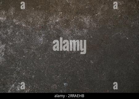 Dark gray concrete surface as grunge background texture for urban themes like subculture, underground or even architecture, full frame, copy space Stock Photo