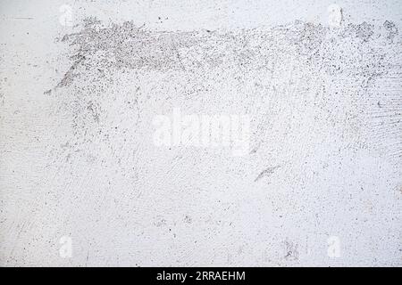 Plastered wall surface with rubbed off white paint, light gray background texture for urban themes or architecture, full frame, copy space Stock Photo