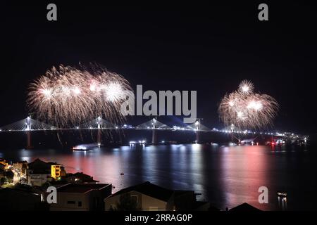210729 -- KOMARNA, July 29, 2021 -- Photo taken on July 29, 2021 shows fireworks celebrating the successful connection of the Peljesac Bridge at Mali Ston Bay near Komarna of southern Croatia. The final piece of steel box girder for the Peljesac Bridge in southern Croatia was lifted and welded with the main structure on late Wednesday night. The 2.4-km cable-stayed bridge over the Mali Ston Bay of the Adriatic Sea connects Croatian mainland and the Peljesac Peninsula of its southernmost Dubrovnik-Neretva County, bypassing a short strip of Bosnian and Herzegovina s territory. /Pixsell via Xinhu Stock Photo