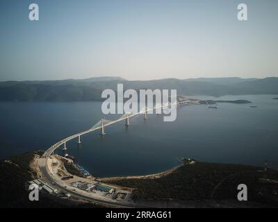 210730 -- KOMARNA, July 30, 2021 -- Aerial photo taken on July 29, 2021 shows the connected Peljesac Bridge at Mali Ston Bay near Komarna of southern Croatia. The final piece of steel box girder for the Peljesac Bridge in southern Croatia was lifted and welded with the main structure on late Wednesday night. The 2.4-km cable-stayed bridge over the Mali Ston Bay of the Adriatic Sea connects Croatian mainland and the Peljesac Peninsula of its southernmost Dubrovnik-Neretva County, bypassing a short strip of Bosnian and Herzegovina s territory.  CROATIA-KOMARNA-PELJESAC BRIDGE GaoxLei PUBLICATION Stock Photo