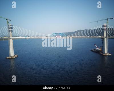 210730 -- KOMARNA, July 30, 2021 -- Aerial photo taken on July 29, 2021 shows the connected final piece of steel box girder of the Peljesac Bridge at Mali Ston Bay near Komarna of southern Croatia. The final piece of steel box girder for the Peljesac Bridge in southern Croatia was lifted and welded with the main structure on late Wednesday night. The 2.4-km cable-stayed bridge over the Mali Ston Bay of the Adriatic Sea connects Croatian mainland and the Peljesac Peninsula of its southernmost Dubrovnik-Neretva County, bypassing a short strip of Bosnian and Herzegovina s territory.  CROATIA-KOMA Stock Photo