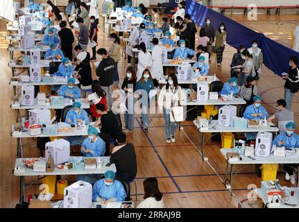 210803 -- BEIJING, Aug. 3, 2021 -- People receive COVID-19 vaccines at a vaccination site in a stadium in Minhang District, east China s Shanghai, March 28, 2021. TO GO WITH XINHUA HEADLINES OF AUG. 3, 2021  CHINA-COVID-19-DELTA VARIANT-MEASURES CN LiuxYing PUBLICATIONxNOTxINxCHN Stock Photo