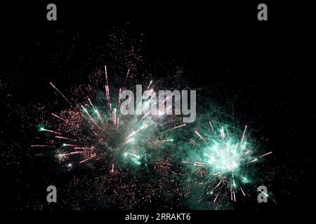 Fireworks in the black night sky Stock Photo