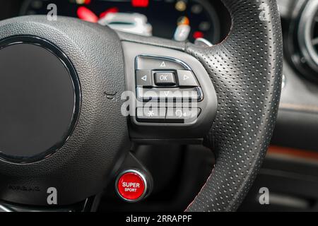 Enhance your driving experience with our steering wheel featuring multi-function buttons for easy access to audio, phone, and cruise control functions Stock Photo