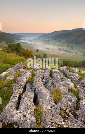 A misty morning view in the Yorkshire Dales, looking up the valley of Upper-Wharfedale. Image taken above Kettlewell, looking towards Buckden Stock Photo