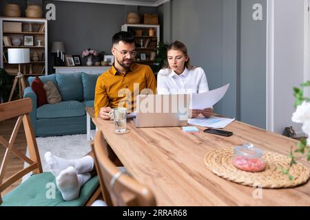 Young freelancer business couple working from home preparing video call presentation with clients on laptop computer webcam with formal suit and casua Stock Photo