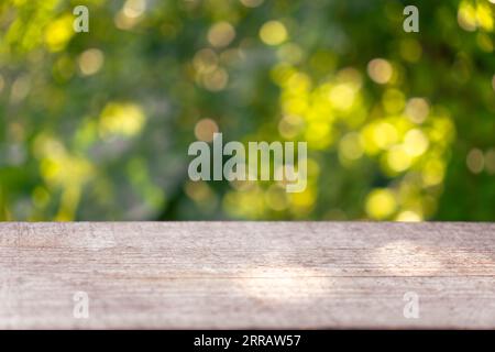 Display mock up, montage your product, design key visual layout. Empty rustic wooden texture of old wood table top, blur against green park with defoc Stock Photo