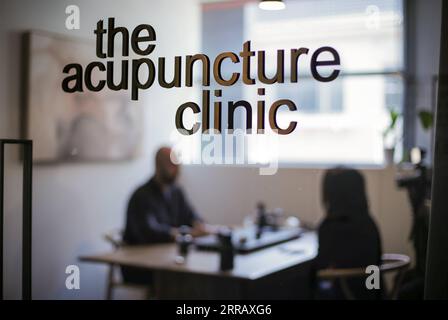 210820 -- SYDNEY, Aug. 20, 2021 -- Daniel Spigelman treats a patient at his acupuncture clinic in Sydney, Australia, June 7, 2021. TO GO WITH Feature: Get to the point of acupuncture -- one Australian man s journey with traditional Chinese medicine  AUSTRALIA-SYDNEY-ACUPUNCTURIST BaixXuefei PUBLICATIONxNOTxINxCHN Stock Photo