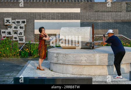 210908 -- TIANJIN, Sept. 8, 2021 -- Tourists take photos at the local cultural park in Xiaoxinmatou Village of Baodi District in Tianjin, north China, Sept. 3, 2021. Li Chao is a post-90s born in Xiaoxinmatou Village in Baodi District. Located by the Chaobai River, the village used to witness an outflow of young people, as villagers made a living by traditional fishing and farming with low income. Like his young fellows, Li chose to be a migrant worker in the city for higher income. Waiter, chef, assembly line worker, security guard and salesman...the diligent man tried his hand at a variety o Stock Photo