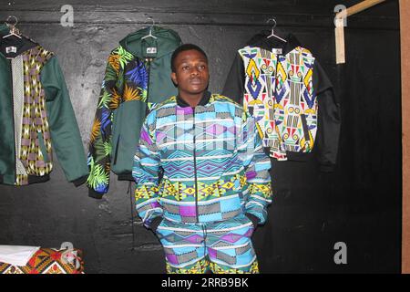 210909 -- HARARE, Sept. 9, 2021 -- A man wearing an outfit made from African print fabric poses for a photo in Harare, capital of Zimbabwe, Sept. 1, 2021. Bakari Sibanda, founder and creative director of Harare-based byBakari fashion brand, uses African print fabric to make stylish clothing that reflects the artistic expression of African culture. TO GO WITH Feature: Zimbabwean fashion entrepreneur fuses tradition with modernity in eye-catching ways  ZIMBABWE-HARARE-FASHION ENTREPRENEUR-AFRICAN PRINT FABRIC TafaraxMugwara PUBLICATIONxNOTxINxCHN Stock Photo