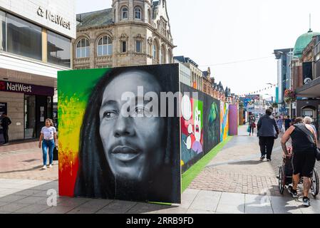 Part of the Southend City Jam graffiti art event around Southend on Sea, Essex, UK. Bob Marley likeness in the High Street shopping area Stock Photo