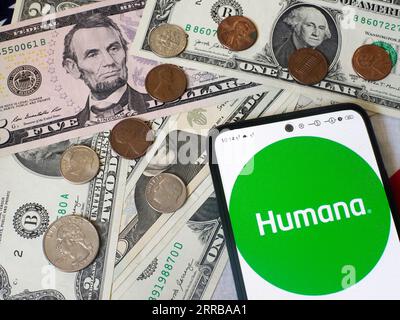 Germany. 5th Sep, 2023. In this photo illustration, the Humana Inc. logo is seen displayed on a smartphone and US currency notes and coins in the background. (Credit Image: © Igor Golovniov/SOPA Images via ZUMA Press Wire) EDITORIAL USAGE ONLY! Not for Commercial USAGE! Stock Photo