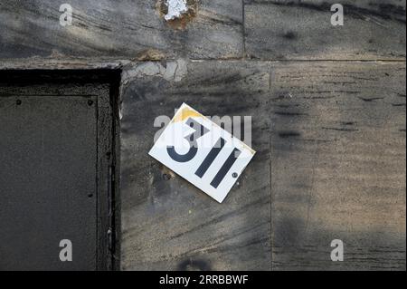 A sloping house number 311 Stock Photo