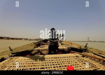 210917 -- KHARTOUM, Sept. 17, 2021 -- A Sudanese child practices rowing a fishing boat on the White Nile in the Sudanese capital Khartoum on Sept. 16, 2021.  SUDAN-KHARTOUM-FISHING BOAT MohamedxKhidir PUBLICATIONxNOTxINxCHN Stock Photo