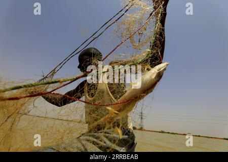 210917 -- KHARTOUM, Sept. 17, 2021 -- A fisherman operates on a fishing boat on the White Nile in the Sudanese capital Khartoum on Sept. 16, 2021.  SUDAN-KHARTOUM-FISHING BOAT MohamedxKhidir PUBLICATIONxNOTxINxCHN Stock Photo