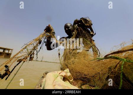 210917 -- KHARTOUM, Sept. 17, 2021 -- A fisherman operates on a fishing boat on the White Nile in the Sudanese capital Khartoum on Sept. 16, 2021.  SUDAN-KHARTOUM-FISHING BOAT MohamedxKhidir PUBLICATIONxNOTxINxCHN Stock Photo