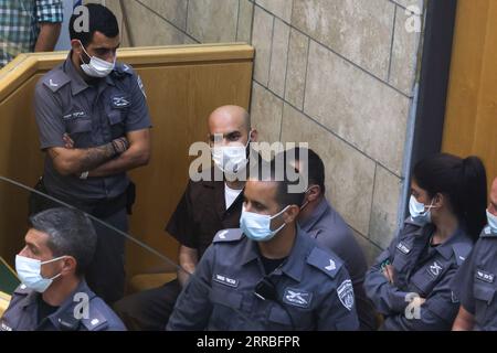 210919 -- NAZARETH ISRAEL, Sept. 19, 2021 -- Ayham Kamamji 3rd L, one of the six Palestinians who escaped a prison earlier in September, is seen surrounded by Israeli police officers at the Magistrates Court in Nazareth, northern Israel, on Sept. 19, 2021. The Israeli army on Sunday said it has arrested the last two of the six Palestinians who had escaped a maximum-security prison in northern Israel earlier in September.  via Xinhua ISRAEL-NAZARETH-PALESTINIAN FUGITIVES-COURT DavidxCohen/JINI PUBLICATIONxNOTxINxCHN Stock Photo