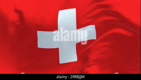 Close-up view of Switzerland national flag waving in the wind. Red background with a white cross in the center. 3d illustration render. Fluttering fab Stock Photo