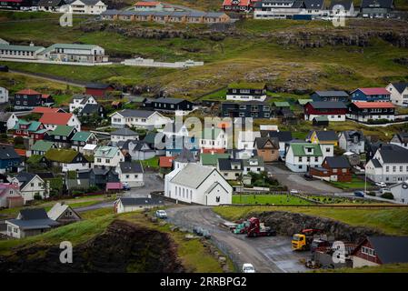 Multi-coloured roofs dot the hillside in the village of Ei∂i on the island of Eysturoy in the Faroe Islands. Stock Photo