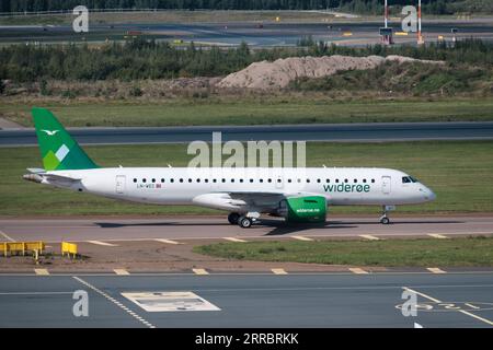 Helsinki / Finland - SEPTEMBER 7, 2023: Helsinki-Vantaa Airport EFHK. An Embraer E190-E2, operated by Wideroe, taxiing at Helsinki Airport. Stock Photo