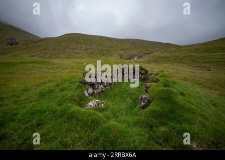 Abandoned sheep croft on a slope among hills on Vagar island in the Faroe Islands. Stock Photo