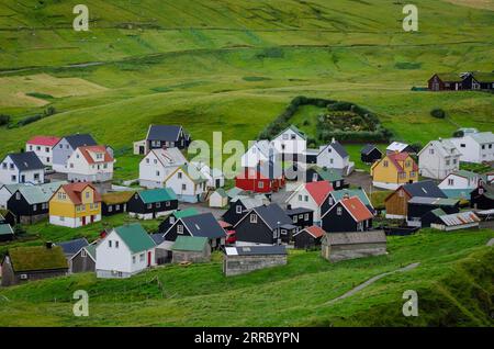 The small village of Gjogv crowds the sea  on the northeast corner of Eysturoy island in the Faroe Islands. Stock Photo