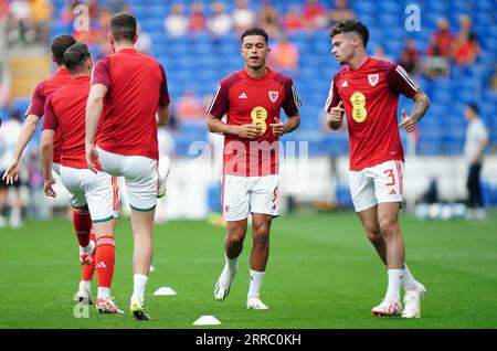 Wales' Brennan Johnson (centre) and Neco Williams (right) warm up ahead of the friendly match at Cardiff City Stadium, Cardiff. Picture date: Thursday September 7, 2023. Stock Photo