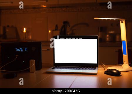 Charging station for laptop and desk lamp when there is no light during blackout. Generator power bank battery in the absence of electricity. at home Stock Photo
