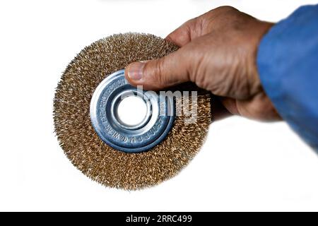 Round wire brush in the people's hand. Insolated on white background Stock Photo