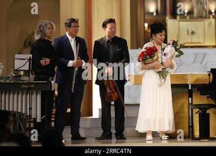 211018 -- PARIS, Oct. 18, 2021 -- Chow Chingling 1st R, Wang Wei 2nd L, Wang Taiping 2nd R and Thierry Miroglio greet the audience during a charity concert dedicated to the disabled in Paris, capital of France, Oct. 17, 2021. The concert, jointly staged by Chinese and French artists with free admission here on Sunday, attracted an audience of more than 300 people.  FRANCE-PARIS-CHARITY CONCERT GaoxJing PUBLICATIONxNOTxINxCHN Stock Photo