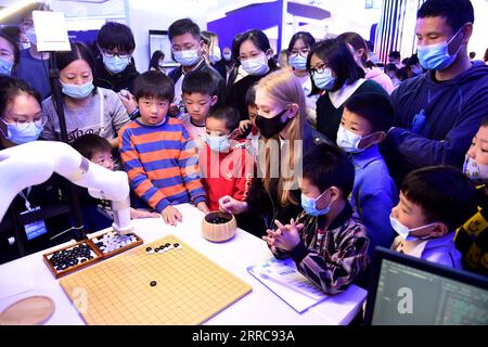 211026 -- HEFEI, Oct. 26, 2021 -- Ukrainian student Aly plays Go game, known as Weiqi in Chinese, with an AI robot at the 4th World Voice Expo in Hefei, capital of east China s Anhui Province, Oct. 24, 2021. Aly has been studying Chinese for seven years and now she is a graduate student at Anhui University. She has spent her time trying high-tech products at the World Voice Expo and believes that these products could make a better life for us. Companies and developers specializing in artificial intelligence AI and speech technology gathered in Hefei, capital of east China s Anhui Province on M Stock Photo
