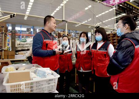 211120 -- XINGTAI, Nov. 20, 2021 -- Yin Mingchao 1st L communicates with new employees in Xingtai, north China s Hebei Province, Nov. 19, 2021. Yin once worked in Beijing as a construction worker after he graduated from college in 2009. The 35-year-old young man wanted to have his own business. Yin accidentally learned that pet product industry was developed well in his hometown Xingtai. He decided to return and start a new career here. Through long time study and try, the business of his online shop stepped into right track gradually. In 2019, Yin registered his own e-commerce brand and set u Stock Photo