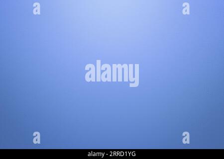 Light blue or blue textured paper background with light effect. High resolution full frame background with copy space. Stock Photo