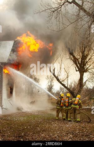 Firefighters training on a burning building Stock Photo